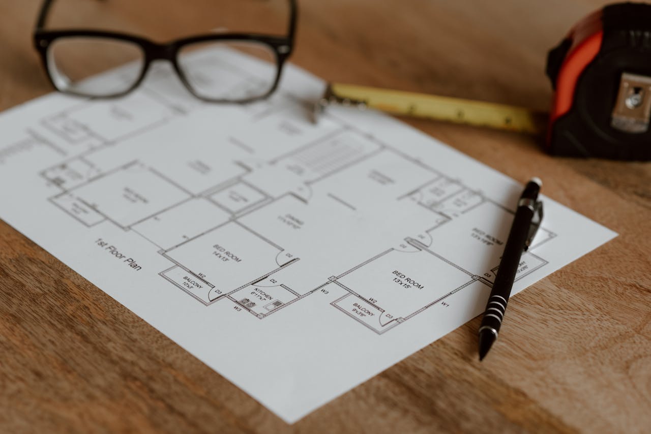 gallery-4 From above of ruler with pencil and glasses placed on paper sheet of house plan for construction